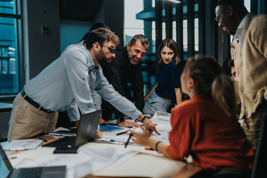 A diverse group of business colleagues engaged in a collaborative brainstorming session, highlighting teamwork and innovative thinking, in a modern office environment. - Powered by Adobe