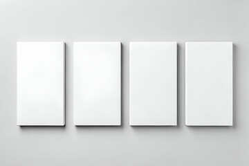Fototapeta premium A minimalist display of four blank canvases on a light gray background, ideal for artistic expression or design projects.