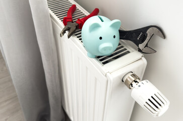 tools on the radiator. water heating radiator on the white wall indoors.