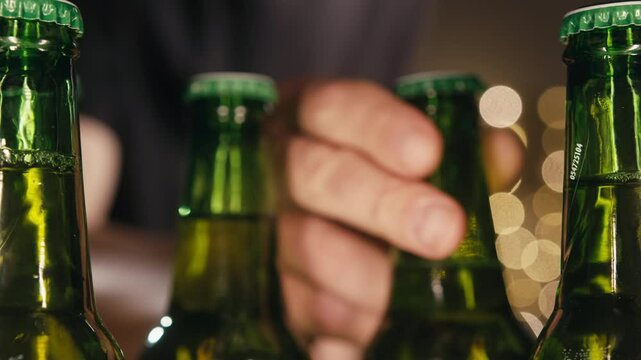 Row of beer bottles in fridge, shop or hotel, cold lager craft german beer or cider, shop supermarket or wine cooler close up.