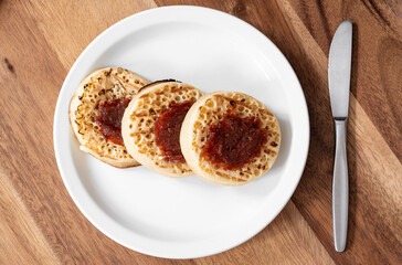 Classic british crumpets with jam on the plate