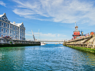 Obraz premium Historic landmarks including the Clock Tower, African Trading Port, and Swing Bridge at Cape Town's V&A Waterfront