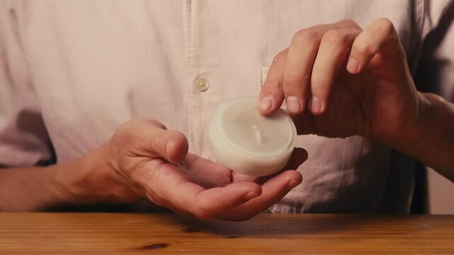 Snus nicotine tobacco close up, pack of tobacco for gum. unhealthy addiction. Man opening box with snus and taking one. 