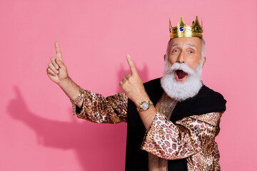 Photo of astonished man leopard coat crown halloween costume point fingers up empty space isolated...