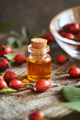 Red rose hip seed oil in a glass bottle