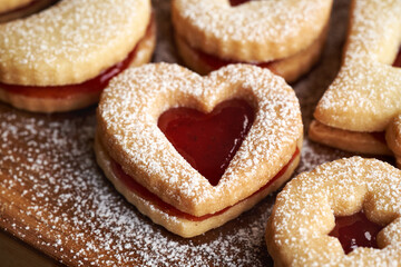 Heart shaped homemade Linzer Christmas cookie filled with strawberry marmalade and dusted with sugar