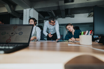 Business team collaborating and discussing projects at a modern office. Focus on brainstorming, analyzing data, and strategizing solutions together for effective project management and task execution.