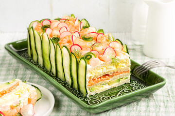 Swedish sandwich or loaf cake Smorgastarta, composed of layers of bread bound with filling egg and...