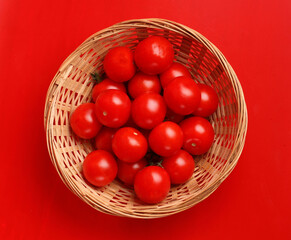 cherry tomatoes bowl on red background