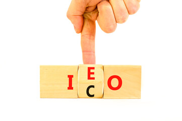 Initial coin or exchange offering symbol. Concept words abbreviation ICO or IEO on wooden block....
