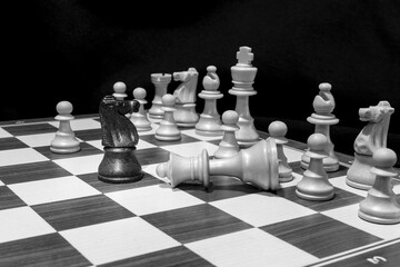 Chessmen photographed on a chessboard with a dark background