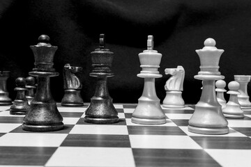 Chessmen photographed on a chessboard with a dark background
