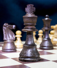 Chessmen photographed on a chessboard with a dark background