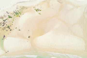 drone aerial view of the shore of a beach with turquoise sea water, background summer concept