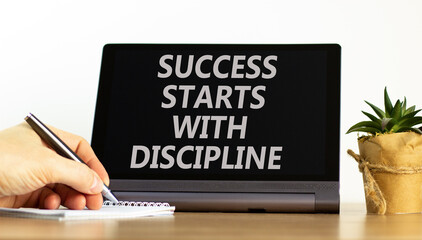 Success starts with discipline symbol. Concept words Success starts with discipline on beautiful black tablet. Beautiful white background. Business success starts with discipline concept. Copy space