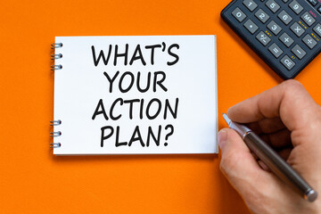 Action plan symbol. Concept words What is your action plan on beautiful white note. Beautiful orange table orange background. Businessman hand. Business What is your action plan concept. Copy space