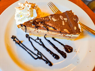 Chocolate cheesecake with nuts on a plate. Healthy food, delicious dessert