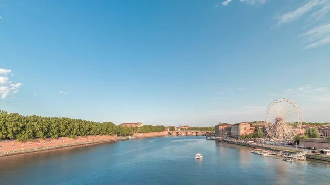 Panorama showing waterfront of Garonne River and Pont Neuf timelapse with Museum of the History of Medicine and ferris wheel in downtown Toulouse, France. Aerial view from Saint Pierre Bridge