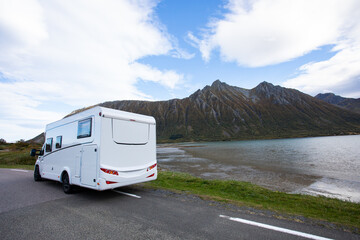 Camper van parked on the side of a road with a beautiful mountain view in bodalen, norway, on a rainy autumn day