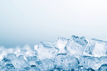 Obraz premium Close-up of clear ice cubes, showcasing their texture and clarity against a soft blue background, perfect for drink-related projects.