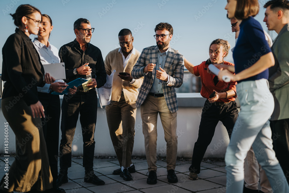 Poster A diverse group of business colleagues gathers on a high tower balcony, celebrating during sunset. The multiracial team enjoys a moment of success and camaraderie in an outdoor setting.