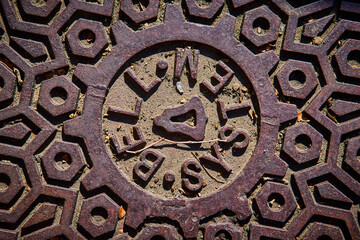 Intricate Manhole Cover Design in Urban Setting Eye-Level Perspective