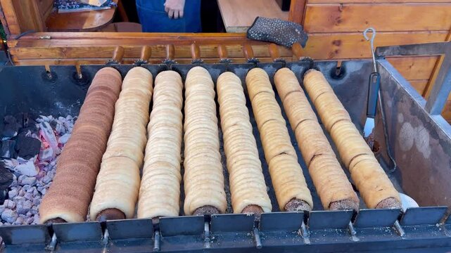 Freshly Baked Trdelnik Chimney spit Cakes on Grill at Czech Christmas Market 