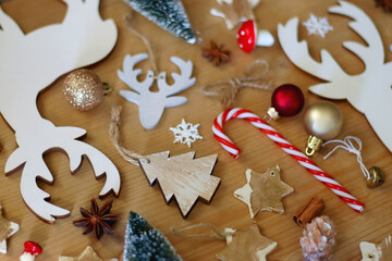 Various Christmas decorations in neutral colors on wooden background. Selective focus.