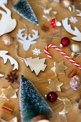 Various Christmas decorations in neutral colors on wooden background. Selective focus.