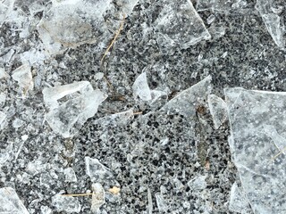 Ice crust on the pavement, paving stones, frozen water on a pavers