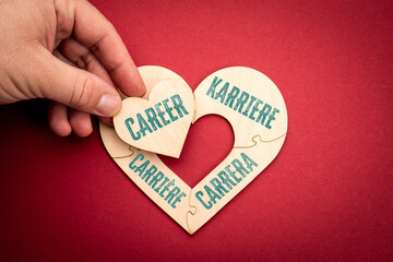 CAREER Concept. Wooden puzzle in the shape of a heart on a red background