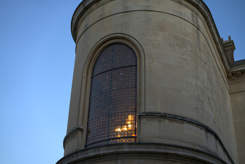 Tower Building with Arched and Curved Window with Light from Inside.