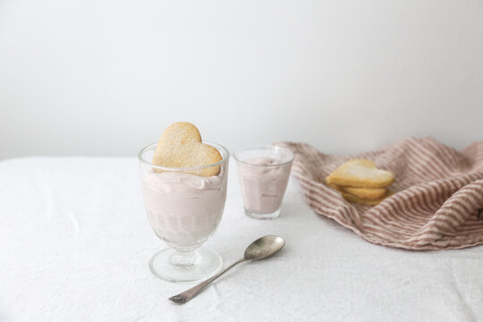 Heart shaped shortbread biscuits with a strawberry mousse dessert