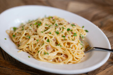 Carbonara pasta, spaghetti with pancetta, egg, hard Parmesan cheese and cream sauce. Traditional Italian cuisine. Pasta alla carbonara.