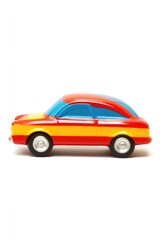 Fototapeta premium A sleek and vibrant toy car with a glossy red and yellow exterior, showcasing a side view against a plain white background, evoking speed and nostalgia.