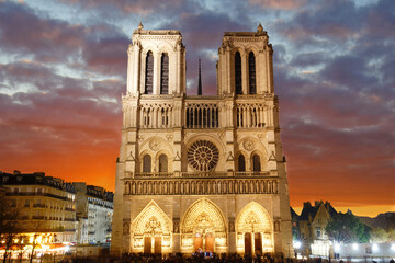 Notre Dame Cathedral in Paris at sunset. It will reopen following a five-year restoration after the 2019 fire. The cathedral will feature a rebuilt spire, restored interiors, and preserved historical