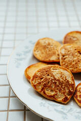 fried pancakes on plate on kitchen table, breakfast on sunny morning. healthy eating, vegetarian. top view of the food. nutritious lunch, delicious and balanced.