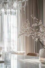 Elegant interior:  chandelier, flowers, glasses, table, sunlight.
