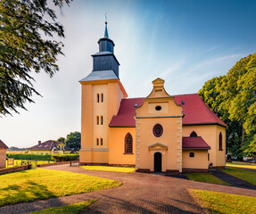 Colorful summer view of Stanislawa Kostki Catholic church. Wonderful evening cityscape of Karnice village, Gryfice County, West Pomerania, Poland, Europe. Traveling concept background. © Andrew Mayovskyy