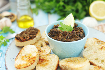A bowl with tapenade - traditional olive dip in Mediterranean region