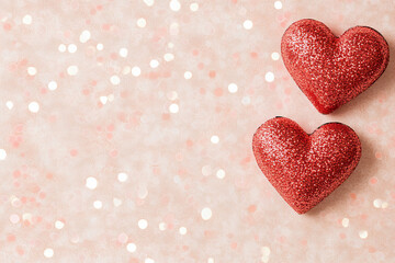 Obraz premium Valentine's Day background with glittering red hearts, soft pink bokeh lights, and sparkling elements perfect for romantic celebrations, love-themed cards, wedding designs, and February holiday projec