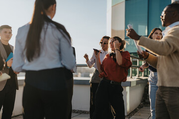 A diverse group of business employees celebrating success with music and dance on a high tower...