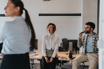 A diverse group of business people engaging in a brainstorming session. They are discussing documents and analyzing ideas, representing a multigenerational workplace environment.