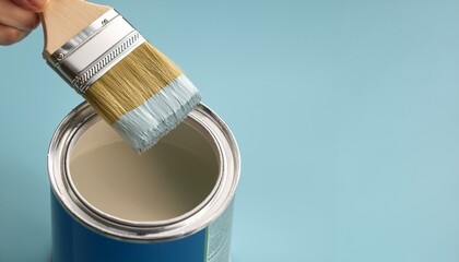 A scene of dipping a brush into an empty can and mixing paint