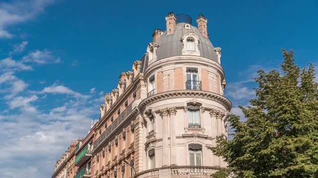 Rue de Metz timelapse in Toulouse, Occitanie, France, with historic facades, shops, cafes and a blue cloudy sky. Vibrant urban scene in the heart of the city