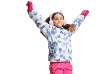 Happy girl in a winter jacket and earmuffs jumping