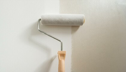 Obraz premium Roller applying paint to wall, scene of smooth rolling on wall