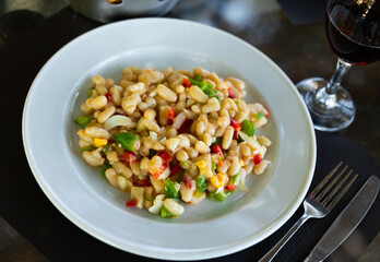 Vegetarian salad vinaigrette with beans close-up in a bowl on the table