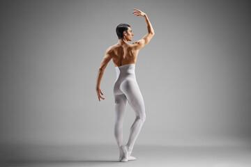 Rear view shot of a ballet dancer in white tights