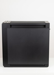 Side view of empty  big tower, PC case, chassis,  Studio shoot on white background. Removable dust filters  at the top and bottom of the computer case.